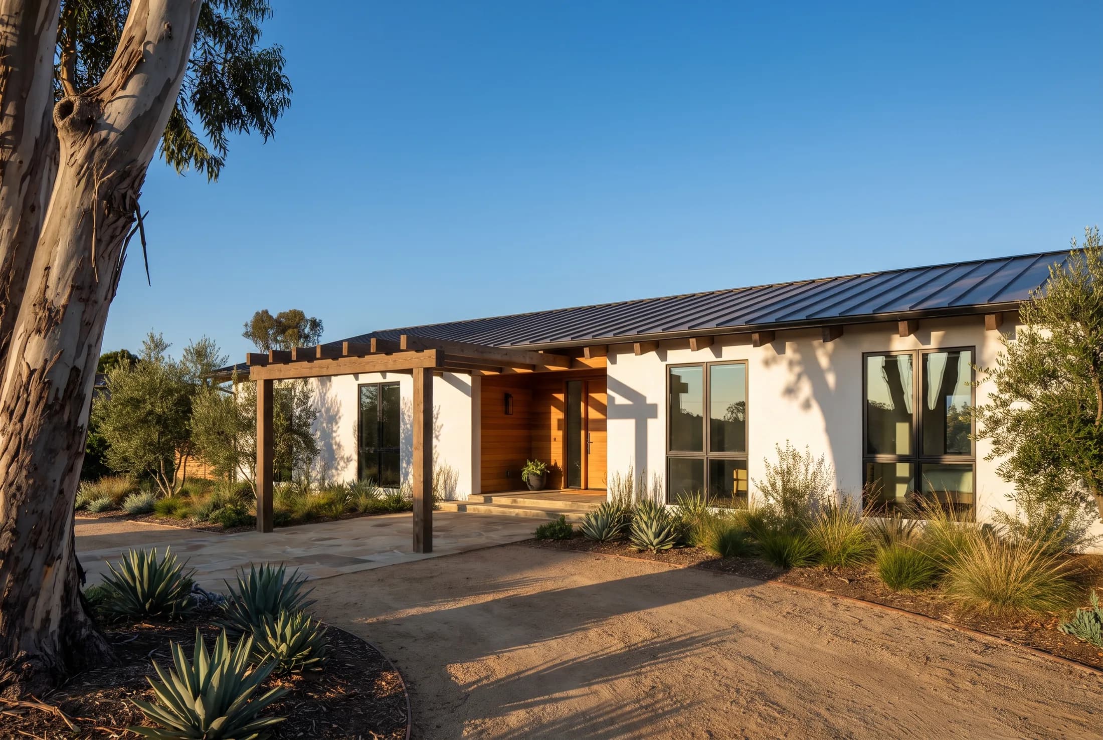Newly completed single-story custom home with a cedar entry, metal roof, and deep exposed rafter tails