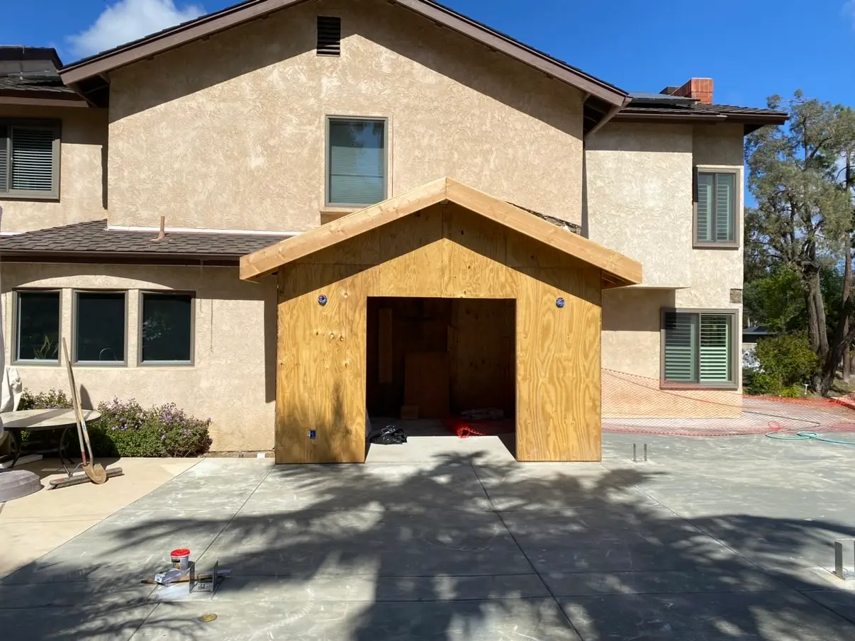 Framed and sheathed dining room addition taking shape behind an Encinitas home