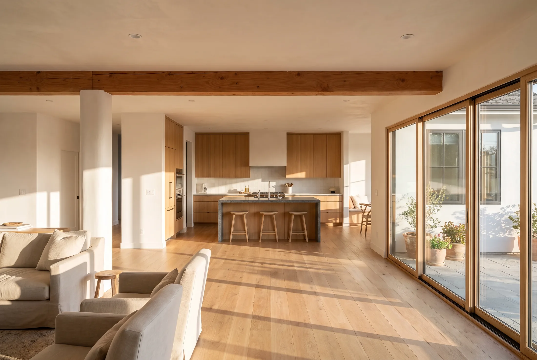 Open-concept living space with an exposed beam after a wall removal in El Cajon, California