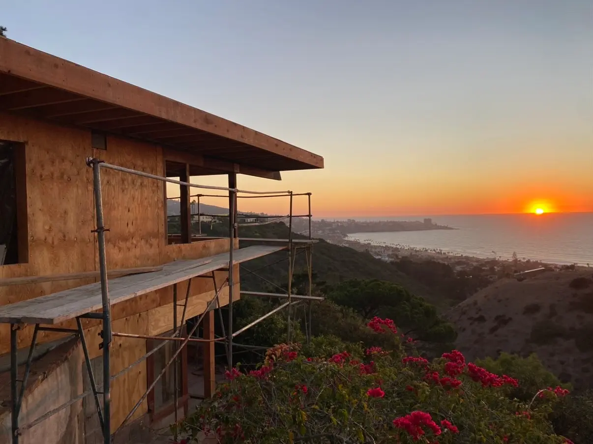 Ocean-facing elevation of a La Jolla build at sunset with scaffolding still up