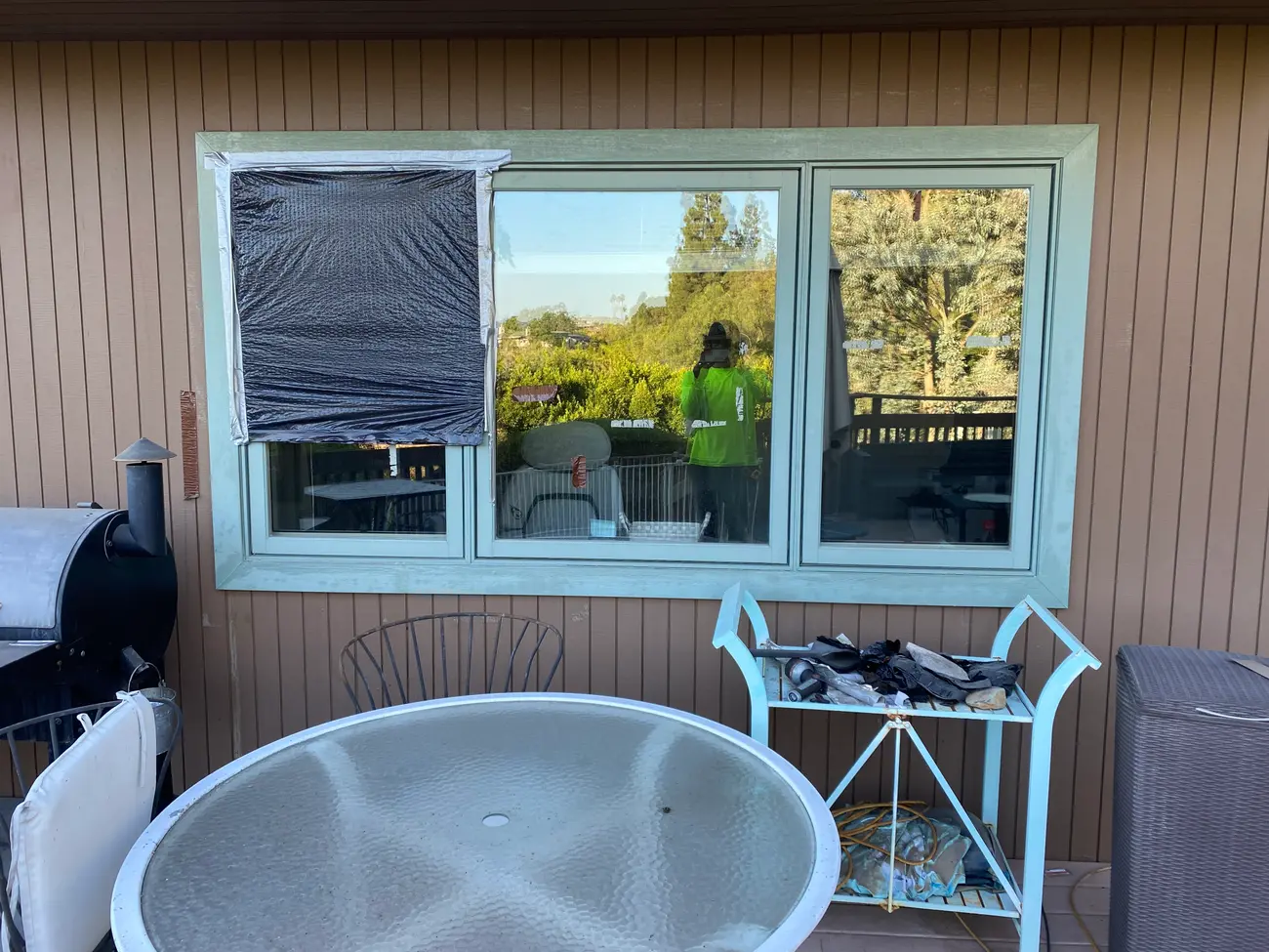The office window before the work, with plastic taped over the section that was letting water in.