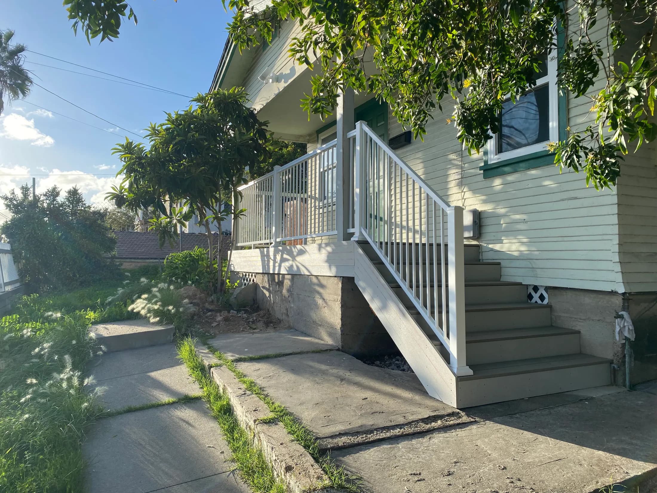 The finished entry from the walkway, stair run and porch both in frame.