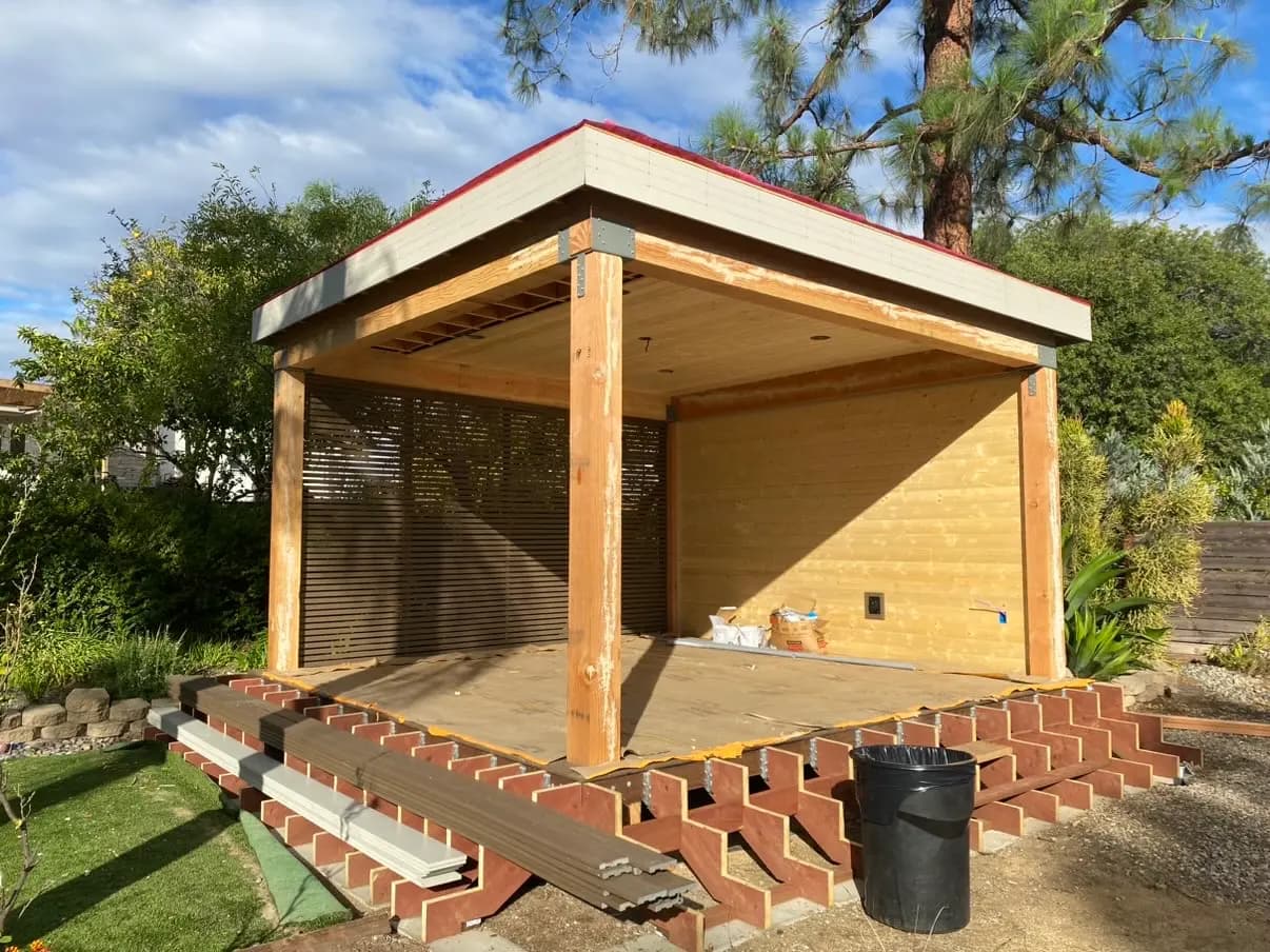 Cedar pavilion and deck with wide stairs stepping down to the lawn in Rancho Bernardo, California