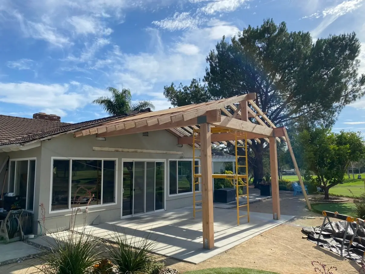 Finished lattice pergola over a patio with outdoor seating