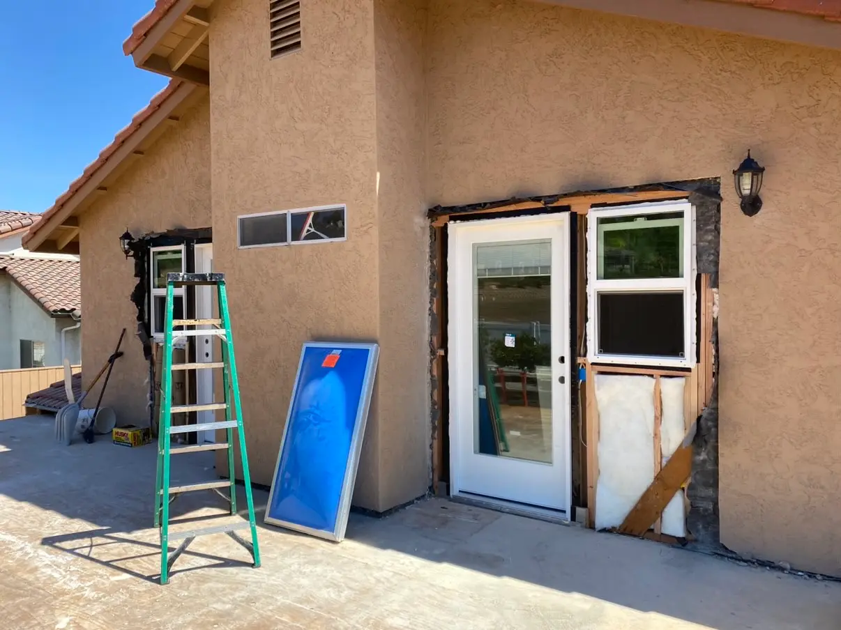 Door and window openings cut and prepared in a stucco wall