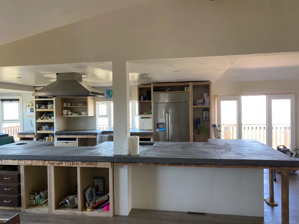 Kitchen with a poured concrete countertop and custom cabinetry in San Marcos