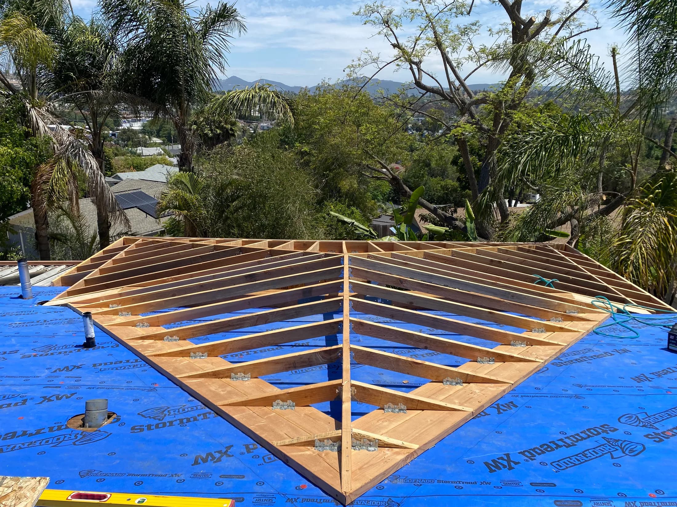 The hip roof framed out over the addition, with the mountains behind it.